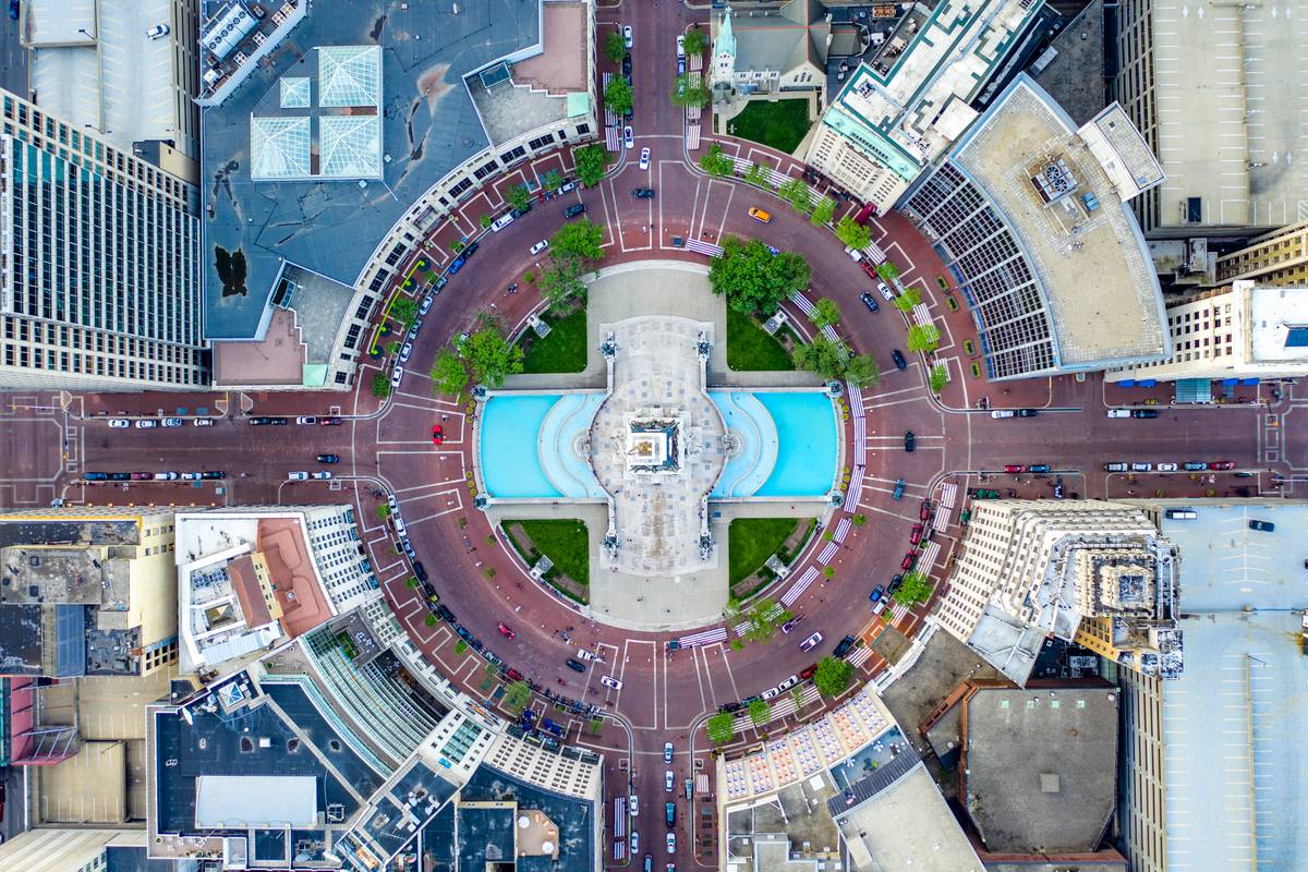 Aerial view looking straight down on Monument Circle in downtown Indianapolis, with the Soldiers' and Sailors' Monument and its fountains at the center of the radial street plan.